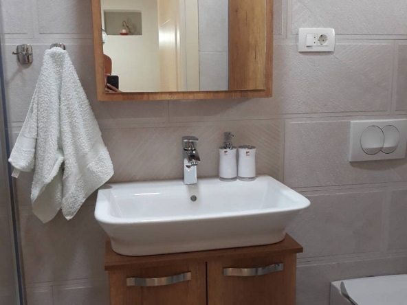 Bathroom with shower, sink, washing machine and toilet