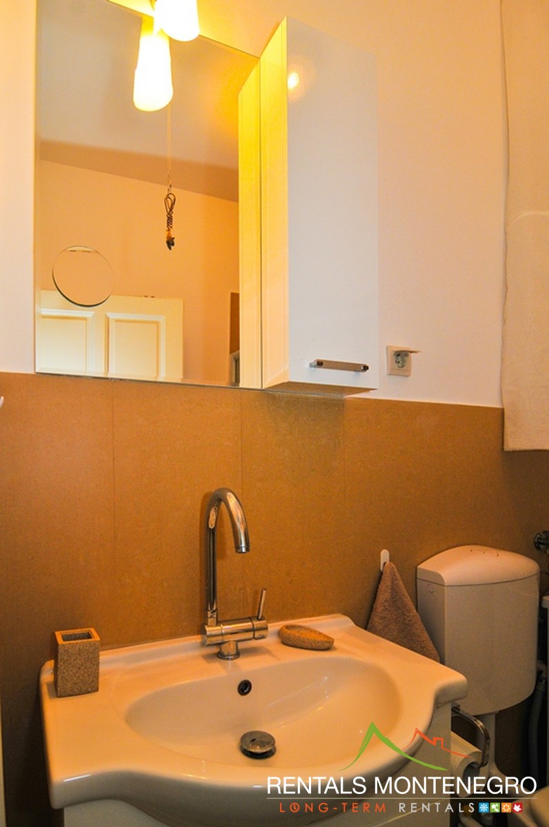 Bathroom with shower, sink, washing machine, toilet in two bedroom apartment
